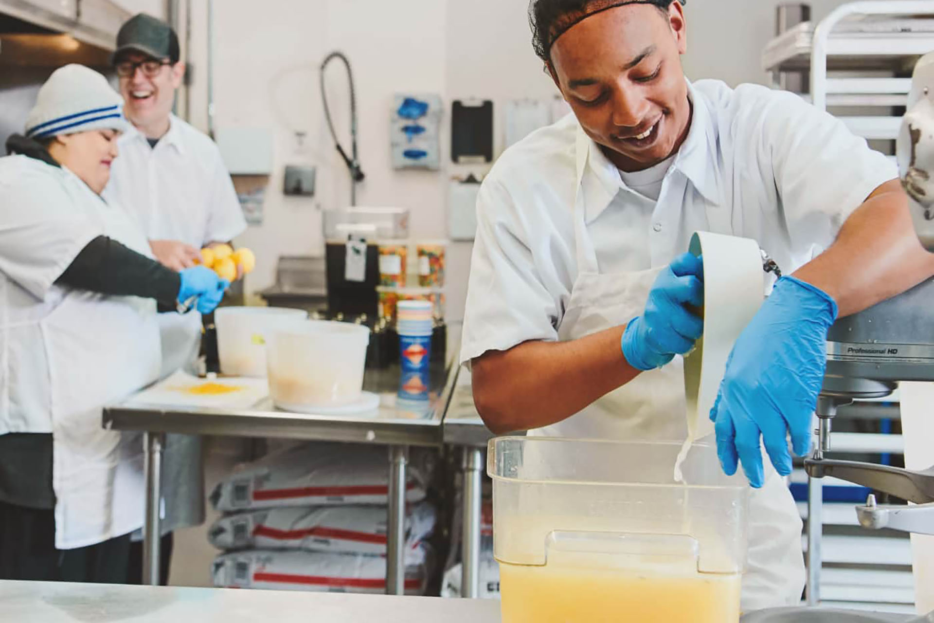 Male worker pouring liquid into a container